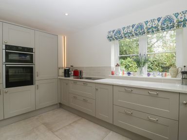 A kitchen featuring appliances and cabinets at St. Marys House Church Westcote near Bledington