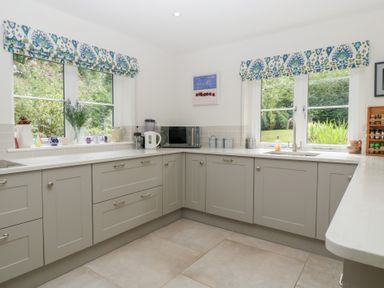 A kitchen with cabinets and a sink at St. Marys House Church Westcote near Bledington