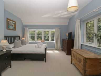 A bedroom with a bed and dresser at St. Marys House Church Westcote near Bledington