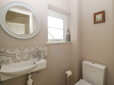 A bathroom with a sink, toilet, and mirror at St. Marys House Church Westcote near Bledington
