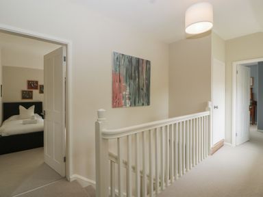 A hallway with a door leading to a bedroom at St. Marys House, Church Westcote near Bledington