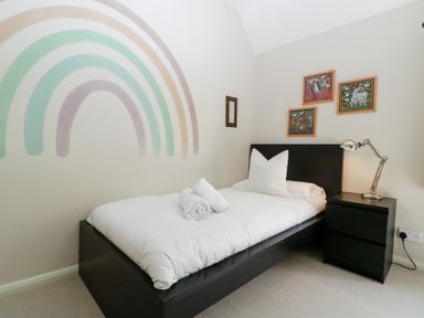 A bedroom with a bed and nightstand at St. Marys House in Church Westcote near Bledington