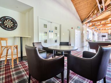 A recreation room with a dartboard and seating at Jubilee First-floor Double Bedroom Penrith