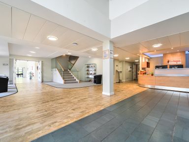 A lobby with a reception desk and staircase at Jubilee First-floor Double Bedroom Penrith