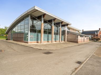 An architectural building with glass windows and a curved roof at Jubilee Bungalow Pet Friendly Sleeps 4 Penrith