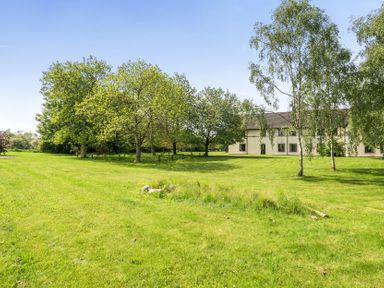 An outdoor view with grass, trees, and a building at Jubilee Bungalow Pet Friendly Sleeps 4 in Penrith