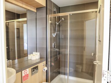 A bathroom with a shower and sink at Bedroom 7 in Penrith