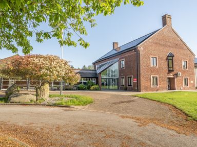 A building with a pathway and tree at Jubilee Ground-floor Double Bedroom in Penrith