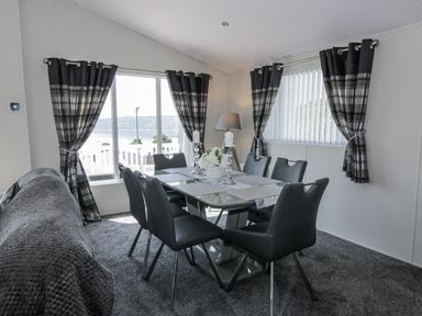 A dining room with a table and chairs at Number 42 in Wemyss Bay