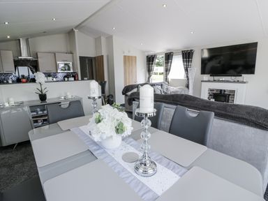 A dining room with a table and chairs at Number 42 Wemyss Bay