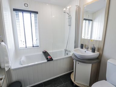 A bathroom with a bathtub and sink at Number 42 in Wemyss Bay