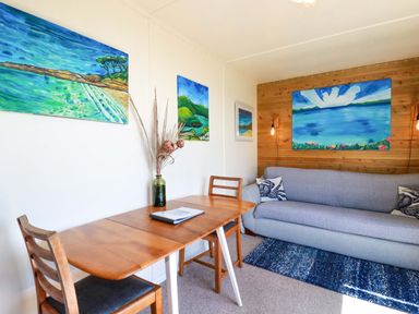 A living room with a table, chair and sofa at The Studio in Feock near Truro