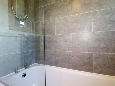 A bathroom with a bathtub and shower at The Studio in Feock near Truro