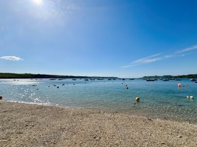 A view of boats on water with a beach at The Studio Feock near Truro