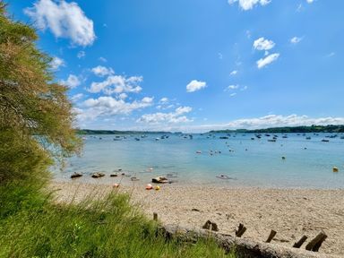 A beach view with boats on the water at The Studio Feock near Truro