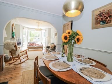 A dining room with a table set for dinner at 18 Pakefield Road in Lowestoft