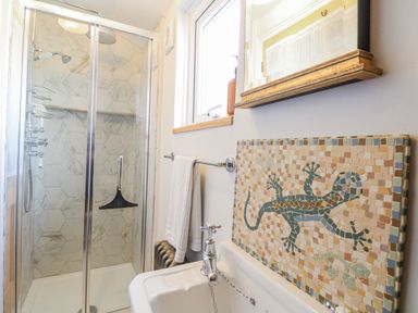 A bathroom featuring a shower and a mosaic tile at 18 Pakefield Road in Lowestoft