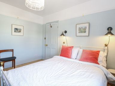 A bedroom with a bed and wall art at 18 Pakefield Road in Lowestoft