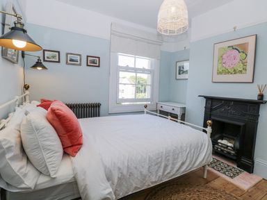 A bedroom with a bed and pictures on the wall at 18 Pakefield Road Lowestoft