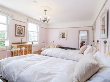 A bedroom with two beds and a dresser at 18 Pakefield Road in Lowestoft