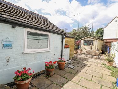 A garden with flower pots and a shed at 18 Pakefield Road in Lowestoft