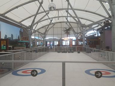 An ice rink with seating and a bar at Pines 15 Porthcawl