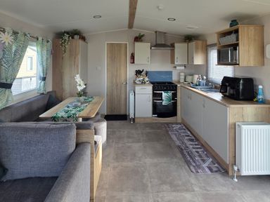 A kitchen with seating area at Pines 15 in Porthcawl