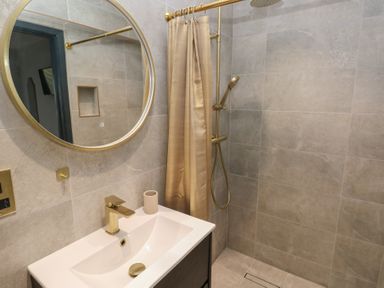 A bathroom with a shower and sink at 10 Brython Place in Tackley