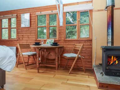 A dining room with a table and chairs at The Boat House in Ashprington