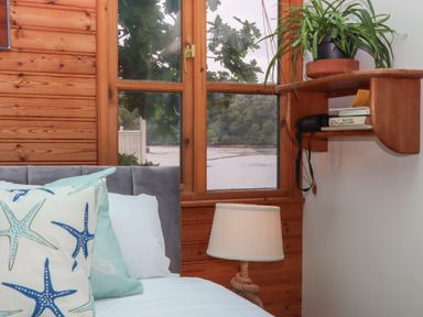 A bedroom with a view of the river at The Boat House in Ashprington