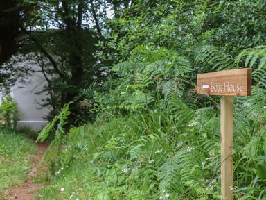 A path leading to a sign for The Boat House in Ashprington