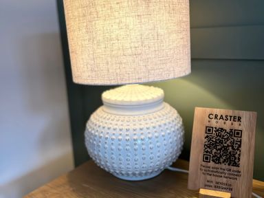 A lamp and wifi information sign at Craster House Seahouses