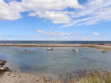A coastal view with boats in the water at Craster House in Seahouses