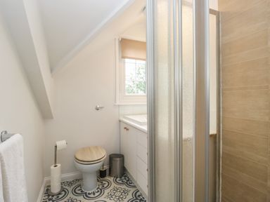A bathroom with a sink, toilet and shower at Cumbria house