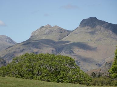 Mountains and greenery in a landscape with a clear sky at Cumbria house
