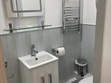A bathroom with a sink and toilet at Noddfa Country House in Harlech