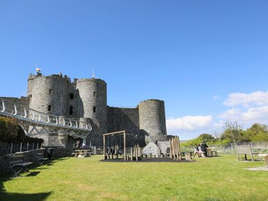 An outdoor area with a castle and playground equipment at Noddfa Country House in Harlech