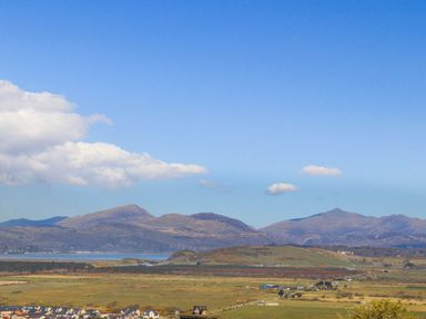 A landscape view of mountains and houses at Noddfa Country House in Harlech
