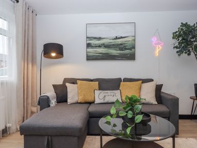 A living room with a sofa and a coffee table at Milana in Tiverton