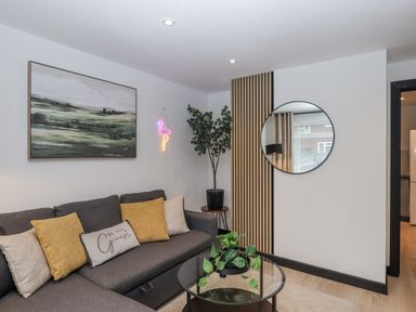 A living room with a sofa and coffee table at Milana in Tiverton