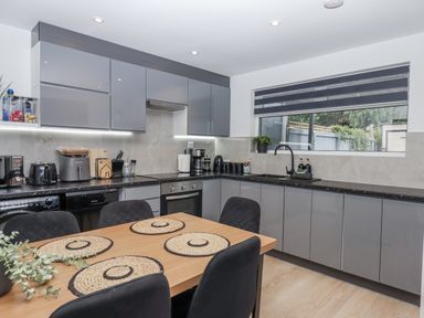 A kitchen with cabinets and appliances at Milana in Tiverton