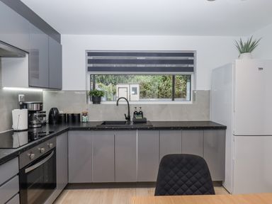 A kitchen with modern appliances and window at Milana in Tiverton