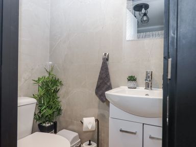 A bathroom with a toilet and sink at Milana in Tiverton