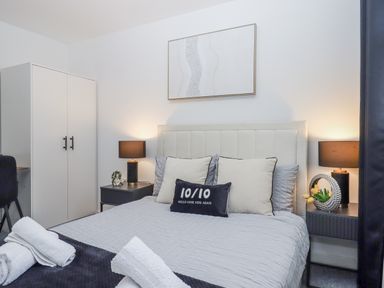 A bedroom with a bed and wardrobe at Milana in Tiverton