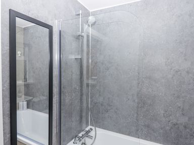 A bathroom with a shower and bathtub at Milana in Tiverton