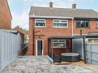 A garden with a hot tub and patio at Milana in Tiverton