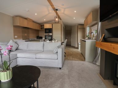 A living room with a sofa and coffee table at The Pines 2 Bedrooms in Delamere
