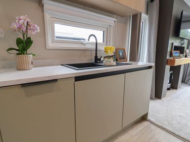 A kitchen with a sink and flower pot at The Pines 2 Bedrooms Delamere