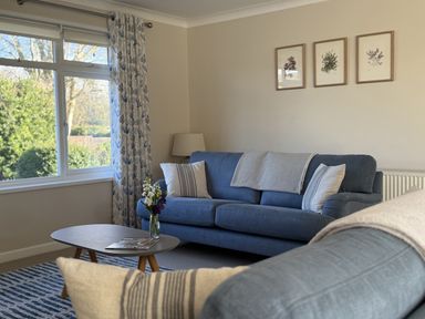 A living room with a sofa and coffee table at 42 Little Trelyn, Rock
