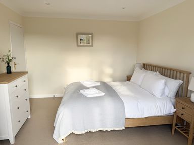 A bedroom with a bed and dresser at 42 Little Trelyn in Rock